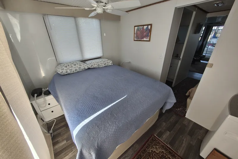 Slide: The Image of Cozy bedroom in 2023 Catamaran Cruisers 1245 with blue bedding and natural light. - 7