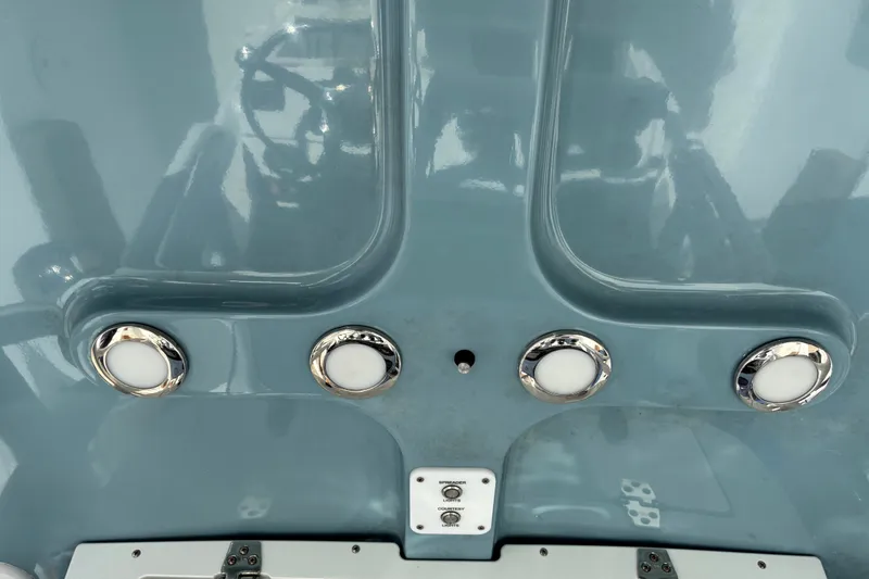 Slide: The Image of 2023 Sea Hunt Ultra 229 boat dashboard with chrome accents and controls. - 44