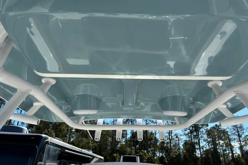 Slide: The Image of 2023 Sea Hunt Ultra 229 boat canopy with rod holders, viewed from below. - 24