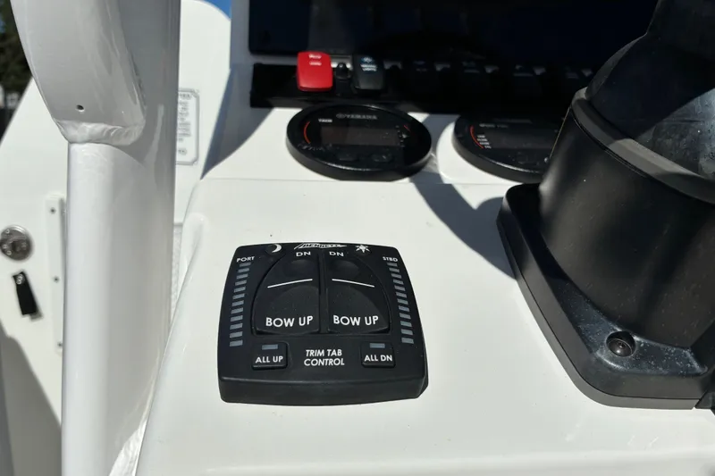 Slide: The Image of 2023 Sea Hunt Ultra 229 boat dashboard with trim tab control panel. - 39