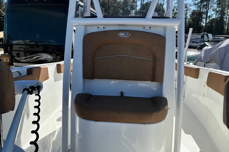 Slide: The Image of 2023 Sea Hunt Ultra 229 boat interior with brown cushioned seating. - 26