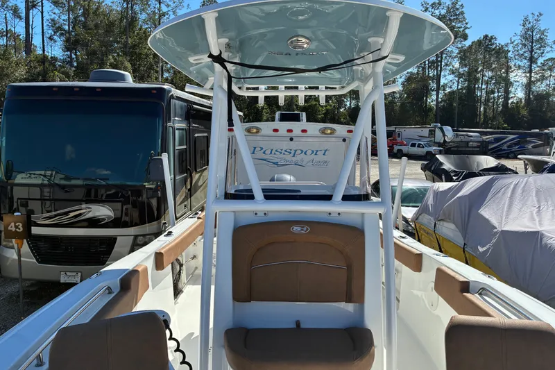 Slide: The Image of 2023 Sea Hunt Ultra 229 boat parked near RVs in a storage area. - 30