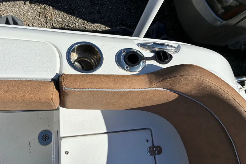 Slide: The Image of 2023 Sea Hunt Ultra 229 boat interior with cup holder and brown seating. - 51
