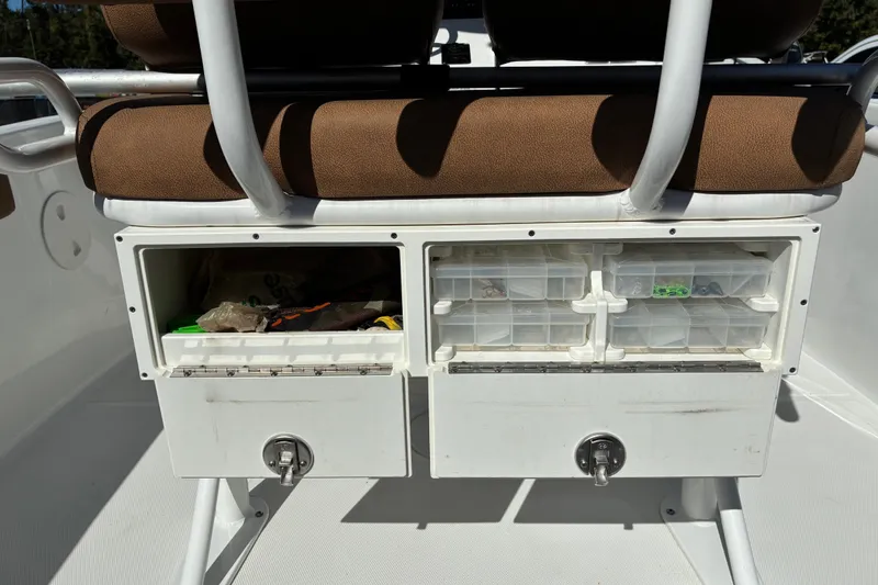 Slide: The Image of Storage compartments on a 2023 Sea Hunt Ultra 229 boat, featuring organized fishing gear. - 56
