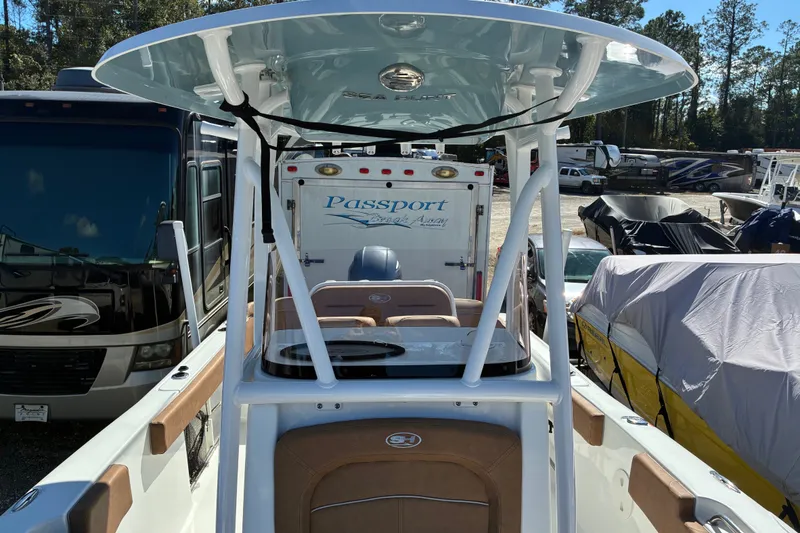 Slide: The Image of 2023 Sea Hunt Ultra 229 boat with T-top, parked among RVs and covered boats. - 33