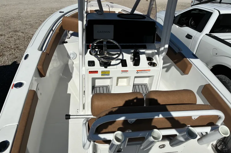Slide: The Image of 2023 Sea Hunt Ultra 229 boat interior with steering console and seating. - 16