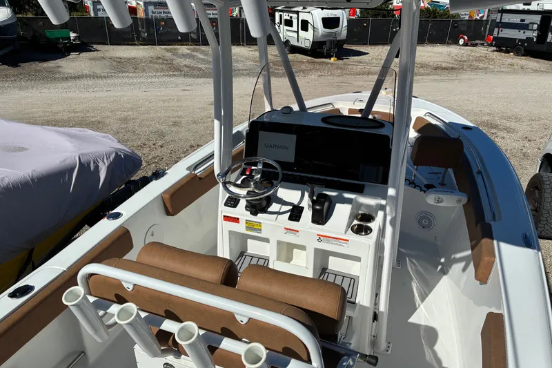 Slide: The Image of 2023 Sea Hunt Ultra 229 boat interior with steering console and seating. - 15
