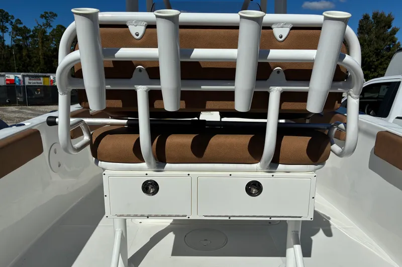 Slide: The Image of 2023 Sea Hunt Ultra 229 boat interior with rod holders and storage compartments. - 57