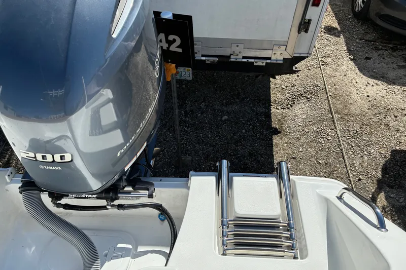 Slide: The Image of 2023 Sea Hunt Ultra 229 boat with Yamaha 200 engine and stainless steel ladder. - 53