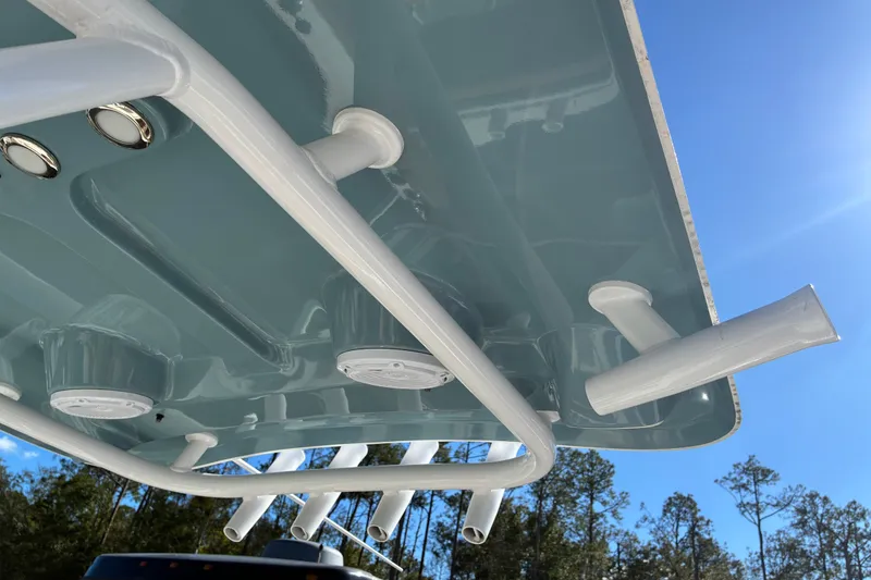 Slide: The Image of 2023 Sea Hunt Ultra 229 boat top view with rod holders and blue sky background. - 22