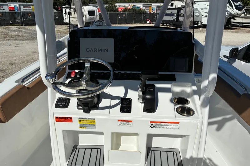 Slide: The Image of 2023 Sea Hunt Ultra 229 boat console with Garmin navigation and steering wheel. - 60