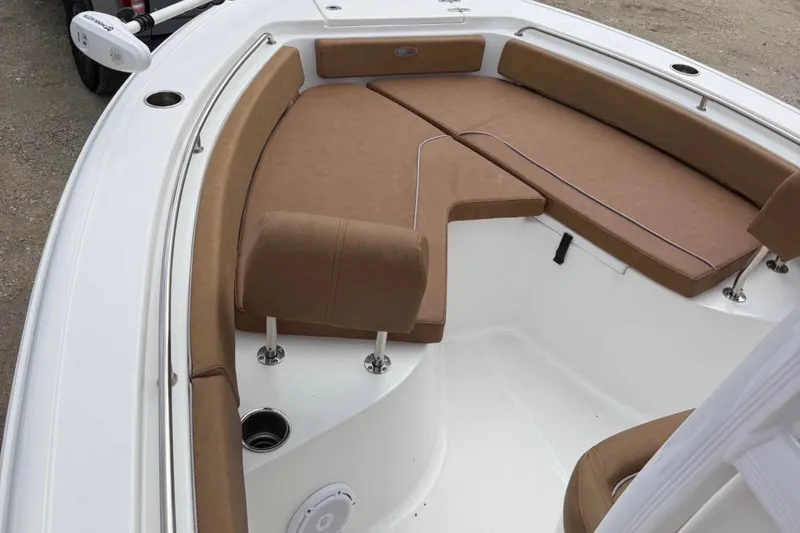 Slide: The Image of 2023 Sea Hunt Ultra 229 boat interior with brown cushioned seating and white deck. - 3