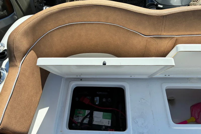 Slide: The Image of 2023 Sea Hunt Ultra 229 boat seat with open storage compartment. - 63