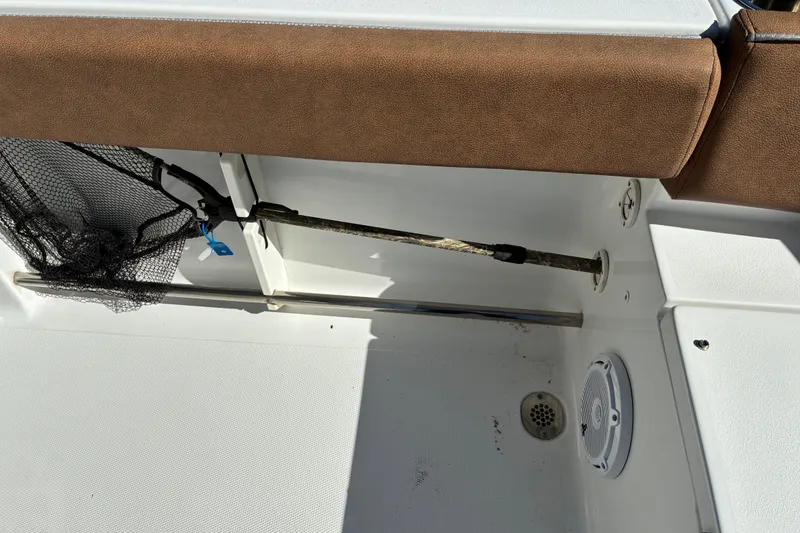 Slide: The Image of 2023 Sea Hunt Ultra 229 boat interior with fishing net and rod holder. - 50