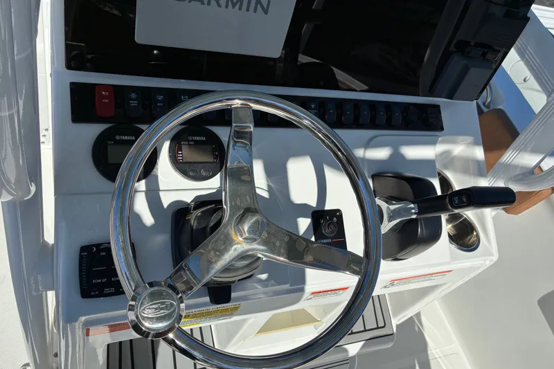 Slide: The Image of Steering console of 2023 Sea Hunt Ultra 229 boat with Yamaha controls and Garmin display. - 46