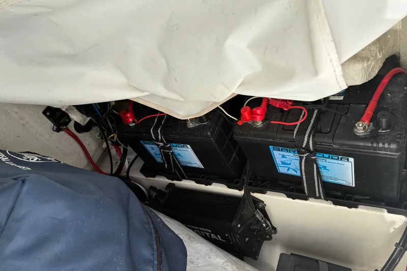 Slide: The Image of Battery compartment of a 2023 Sea Hunt Ultra 229 boat with secured wiring. - 42