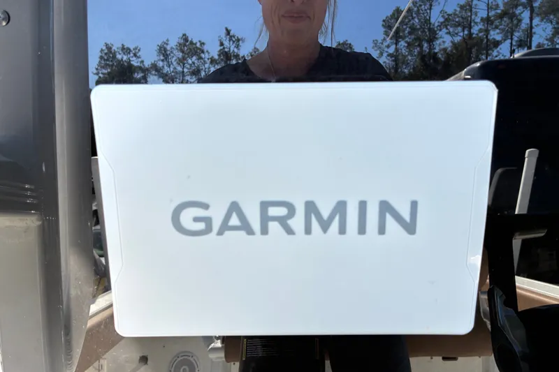Slide: The Image of Garmin device on 2023 Sea Hunt Ultra 229 boat, outdoors with trees in background. - 14