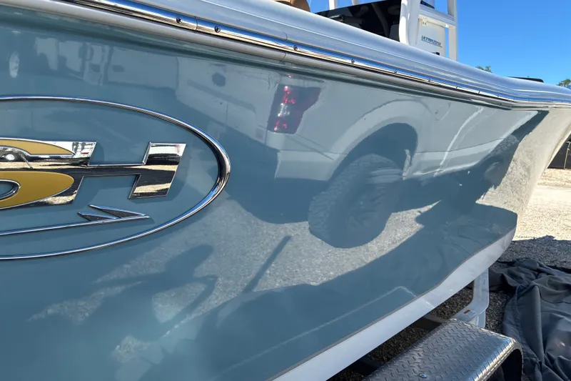 Slide: The Image of 2023 Sea Hunt Ultra 229 boat side view with logo and reflection. - 13
