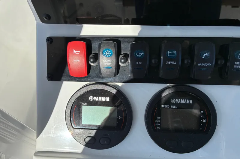 Slide: The Image of Control panel of 2023 Sea Hunt Ultra 229 boat with Yamaha gauges and switches. - 10