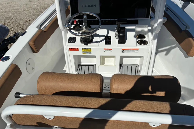 Slide: The Image of 2023 Sea Hunt Ultra 229 boat cockpit with steering wheel and controls. - 59