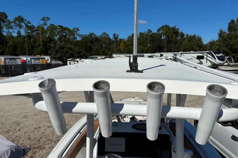 Slide: The Image of 2023 Sea Hunt Ultra 229 boat with rod holders and Garmin equipment, parked outdoors. - 18