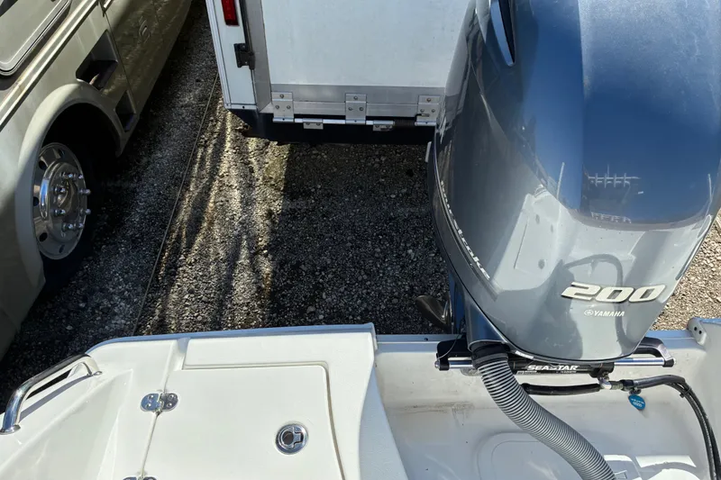 Slide: The Image of 2023 Sea Hunt Ultra 229 boat with Yamaha 200 engine in parking area. - 52