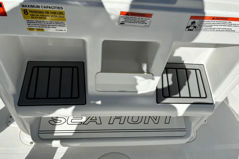 Slide: The Image of 2023 Sea Hunt Ultra 229 boat interior with capacity and safety warnings. - 47
