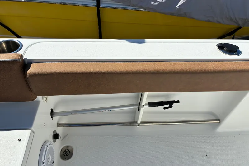 Slide: The Image of 2023 Sea Hunt Ultra 229 boat interior with cushioned seating and rod holder. - 55