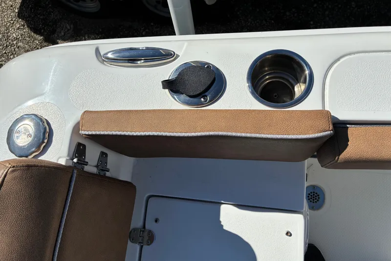 Slide: The Image of 2023 Sea Hunt Ultra 229 boat interior with cup holder and brown seating. - 54
