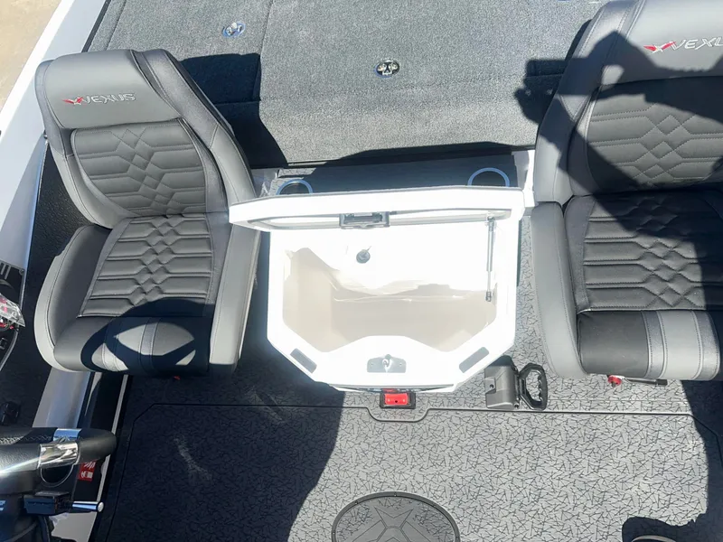 Slide: The Image of Two black seats with quilted pattern and a white storage compartment in between. - 3
