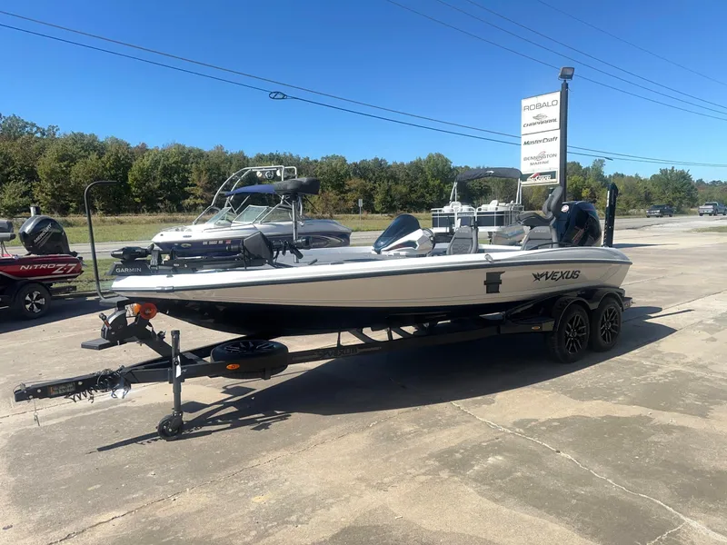 Slide: The Image of A 2027 Vexus VXs21 boat on a trailer in an outdoor setting. - 12