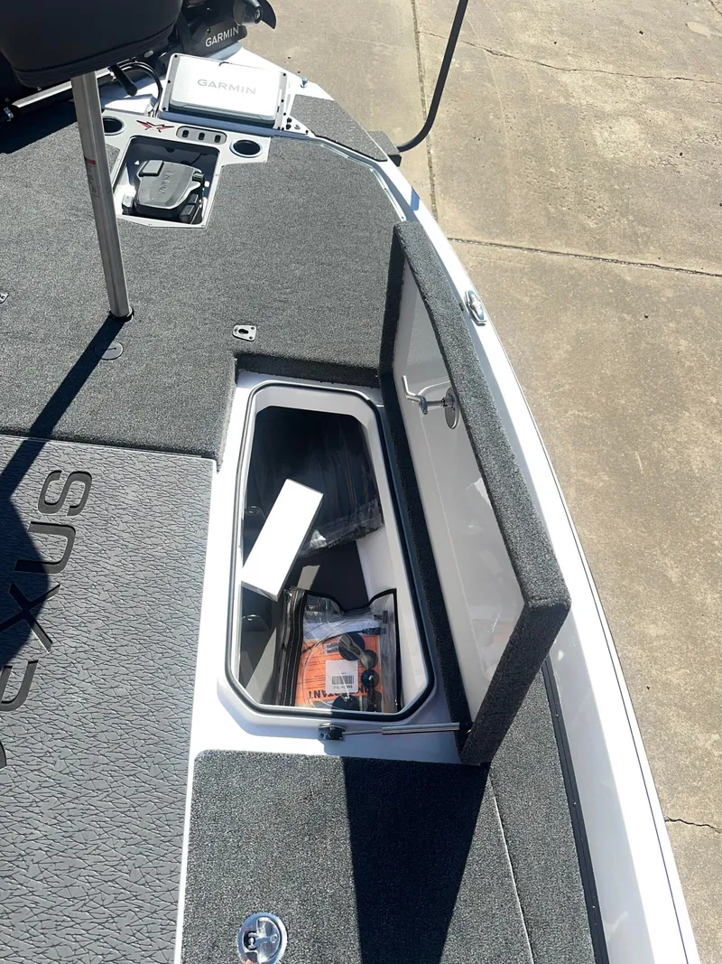 Slide: The Image of The image shows the deck of a 2027 Vexus VXs21 boat with an open storage compartment. - 8