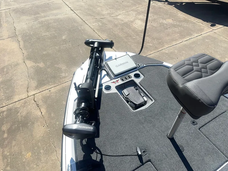 Slide: The Image of The image shows the deck of a Vexus VXs21 boat with a Garmin device and a seat. - 17