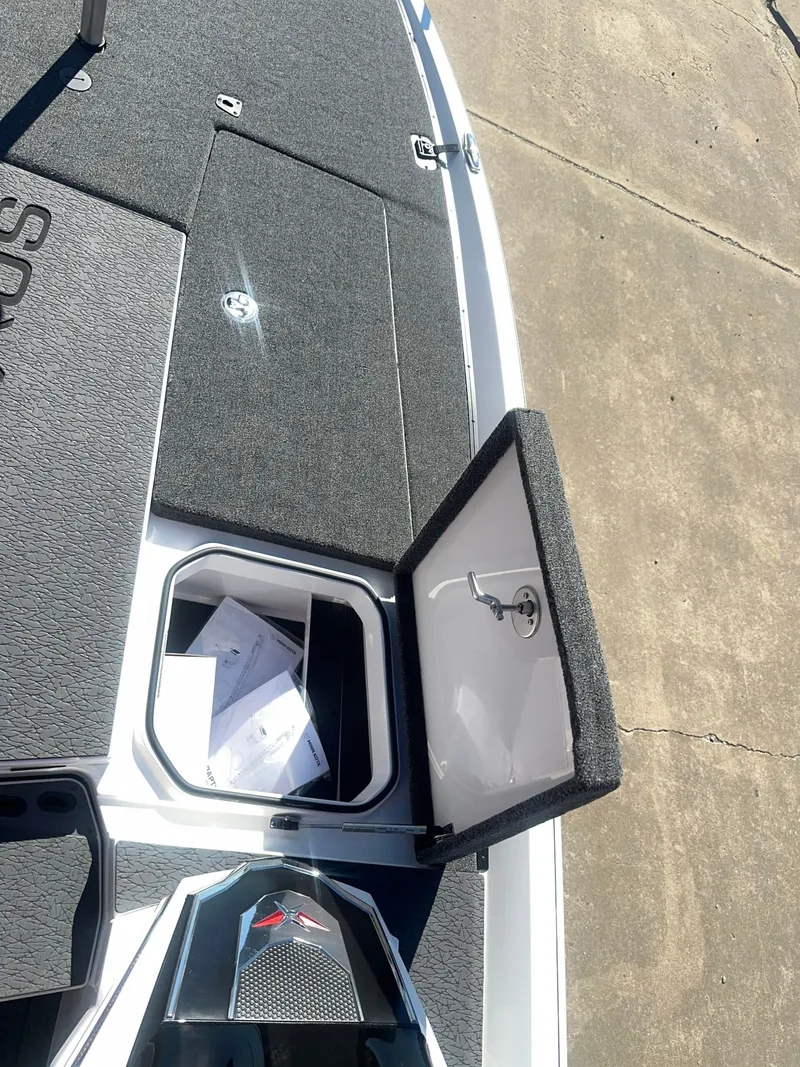 Slide: The Image of The image shows the deck of a Vexus VXs21 boat with an open storage compartment. - 7