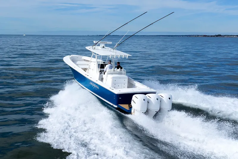 Slide: The Image of A blue boat with three outboard engines speeds across the sea. - 1