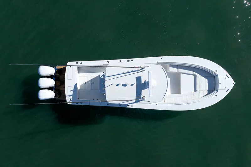 Slide: The Image of Aerial view of a white 2018 Regulator 34SS boat on calm water. - 3