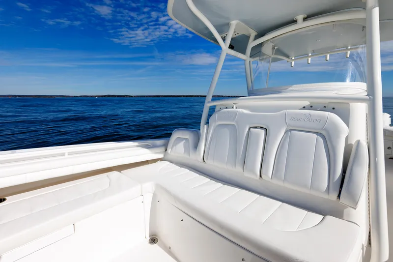 Slide: The Image of The image shows the cockpit of a 2018 Regulator 34SS boat with white seating and blue water in the background. - 13