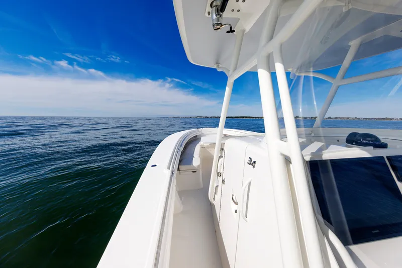 Slide: The Image of A 2018 Regulator 34SS boat on calm water with a clear sky in the background. - 17