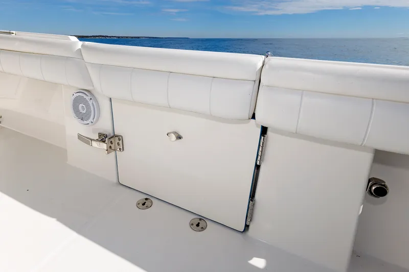 Slide: The Image of The image shows the deck of a 2018 Regulator 34SS boat with white upholstery and a speaker. - 30
