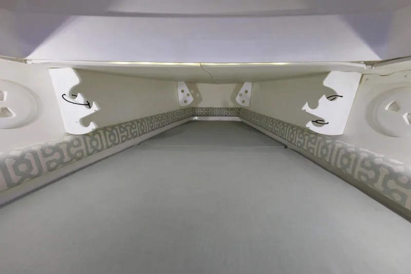 Slide: The Image of Interior view of a boat cabin area with padded sides and white walls. - 42