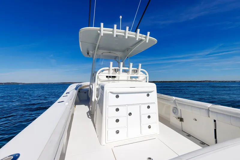 Slide: The Image of A 2018 Regulator 34SS boat on open water. It features a central console and rod holders. - 26