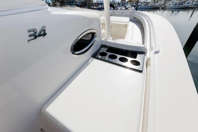 Slide: The Image of The image shows the deck of a 2018 Regulator 34SS boat with cup holders. - 46