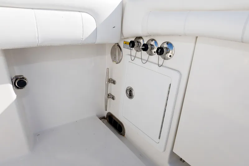 Slide: The Image of The image shows the white interior of a boat with several fittings and a small storage compartment. - 36