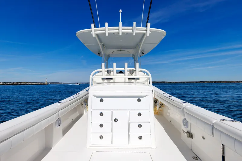 Slide: The Image of The image shows the deck of a 2018 Regulator 34SS boat on calm waters. - 25