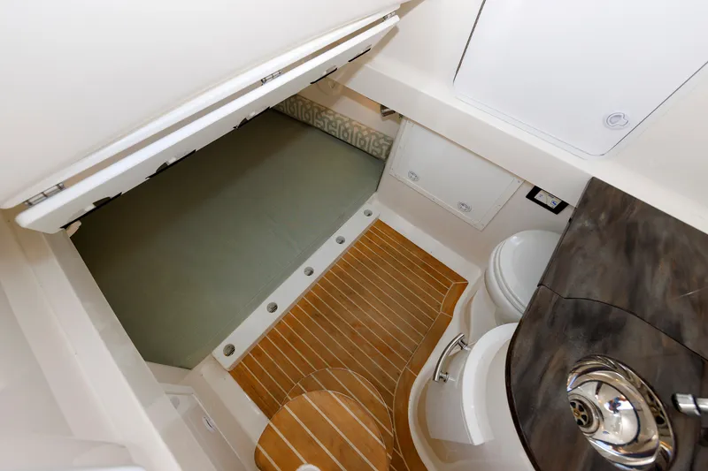 Slide: The Image of Interior of a 2018 Regulator 34SS with wood flooring, seating area, and sink. - 44