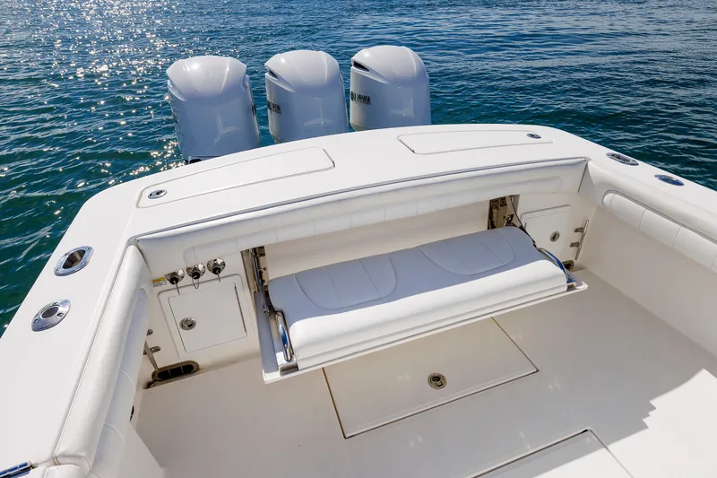 Slide: The Image of The image shows the stern of a 2018 Regulator 34SS boat with three outboard engines. - 31