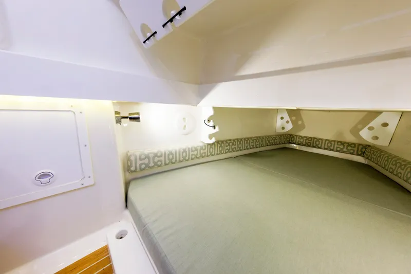 Slide: The Image of Interior of a 2018 Regulator 34SS featuring a cozy sleeping area with soft cushions. - 43