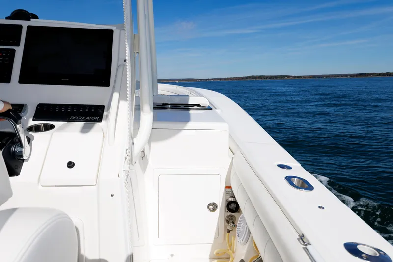 Slide: The Image of The image shows the cockpit of a Regulator 34SS boat on the water. - 18