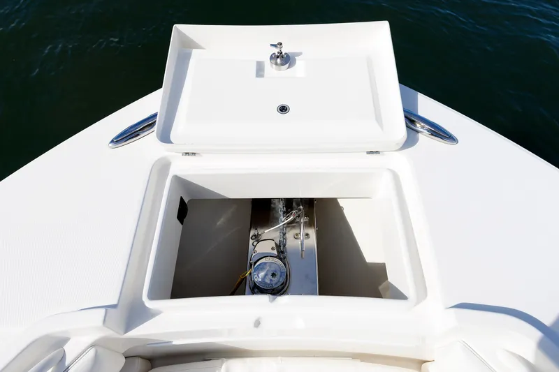 Slide: The Image of The image shows the bow of a Regulator 34SS boat with an open storage compartment. - 16
