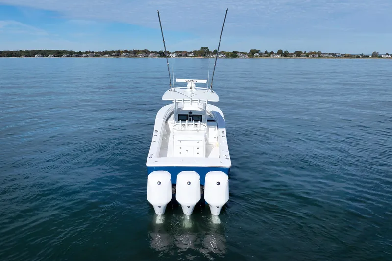 Slide: The Image of A 2018 Regulator 34SS with three outboard engines on calm water. - 8